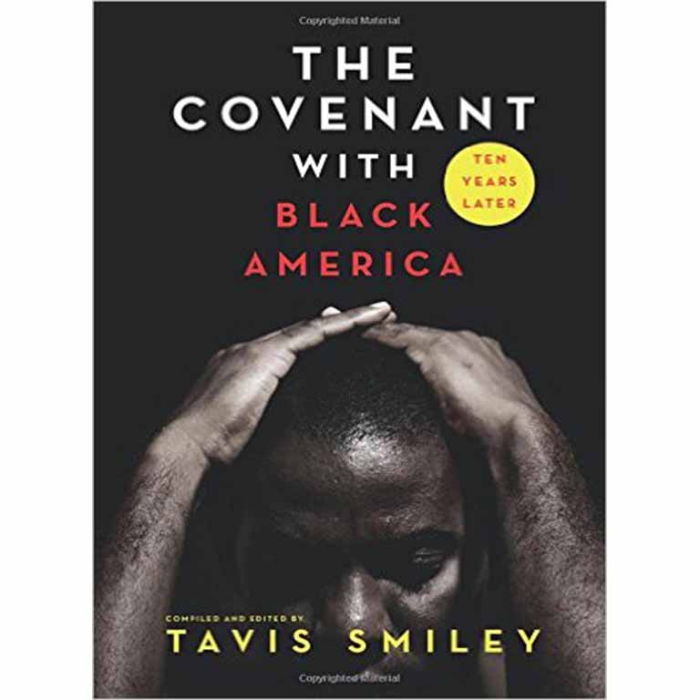 James Barnes in front of a wall of photos. 