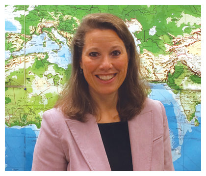 James Barnes in front of a wall of photos. 