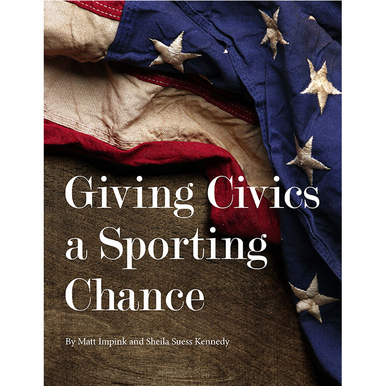 James Barnes in front of a wall of photos. 