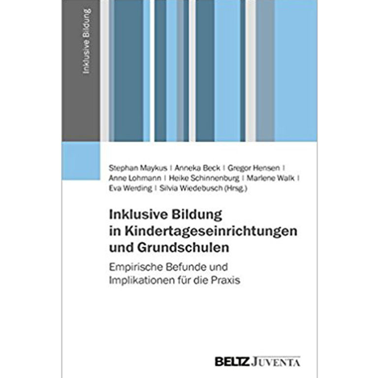 James Barnes in front of a wall of photos. 